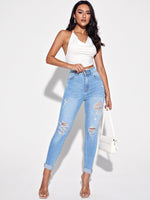 Jeans skinny strappati con vita alta