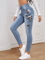 Jeans skinny con ricamo floreale