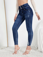 Jeans skinny strappati dettaglio bottone