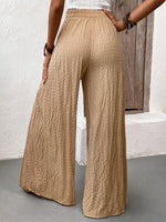 Pantalone casual estivo in tessuto a pieghe solido con vestibilitˆ ampia e taglio largo diviso