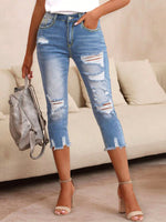 Pantaloni capri denim skinny strappati da donna