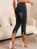 Pantaloni capri denim skinny strappati da donna