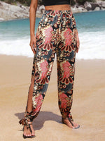 Pantaloni monocolore con orlo annodato a fessura