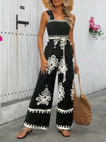 Tuta estiva a gamba larga con stampa floreale a vita alta e bretelle incrociate dietro per donna