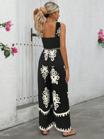 Tuta estiva a gamba larga con stampa floreale a vita alta e bretelle incrociate dietro per donna