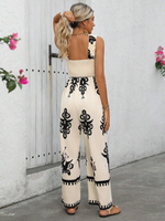 Tuta estiva a gamba larga con stampa floreale a vita alta e bretelle incrociate dietro per donna