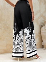 Pantaloni a gamba larga plissettati con stampa floreale e tasche oblique dallo stile vacanziero