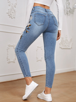 Jeans skinny con ricamo floreale