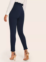 Pantaloni skinny con nodo e vita a volant sovrapposti