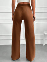 Pantaloni vita alta con bottone frontale