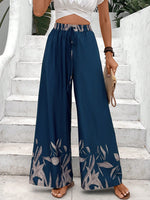 Pantaloni a gamba larga a vita alta con stampa floreale e dettaglio di fiocco sul davanti per donne, neri