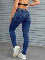 Jeans skinny vita alta con bottone