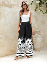 Pantaloni a gamba larga plissettati con stampa floreale e tasche oblique dallo stile vacanziero