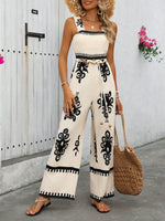 Tuta estiva a gamba larga con stampa floreale a vita alta e bretelle incrociate dietro per donna