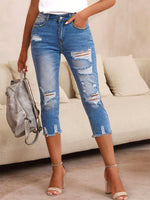 Pantaloni capri denim skinny strappati da donna