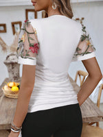 Maglietta nera slim fit da donna con inserti in mesh ricamati floreali