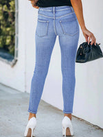 Jeans skinny strappati