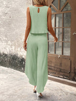 Top di stile vacanziero elegante stampato a pois per signore con pantaloni a gamba larga con spacco avanti