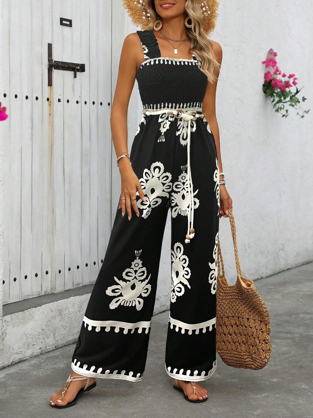 Tuta estiva a gamba larga con stampa floreale a vita alta e bretelle incrociate dietro per donna