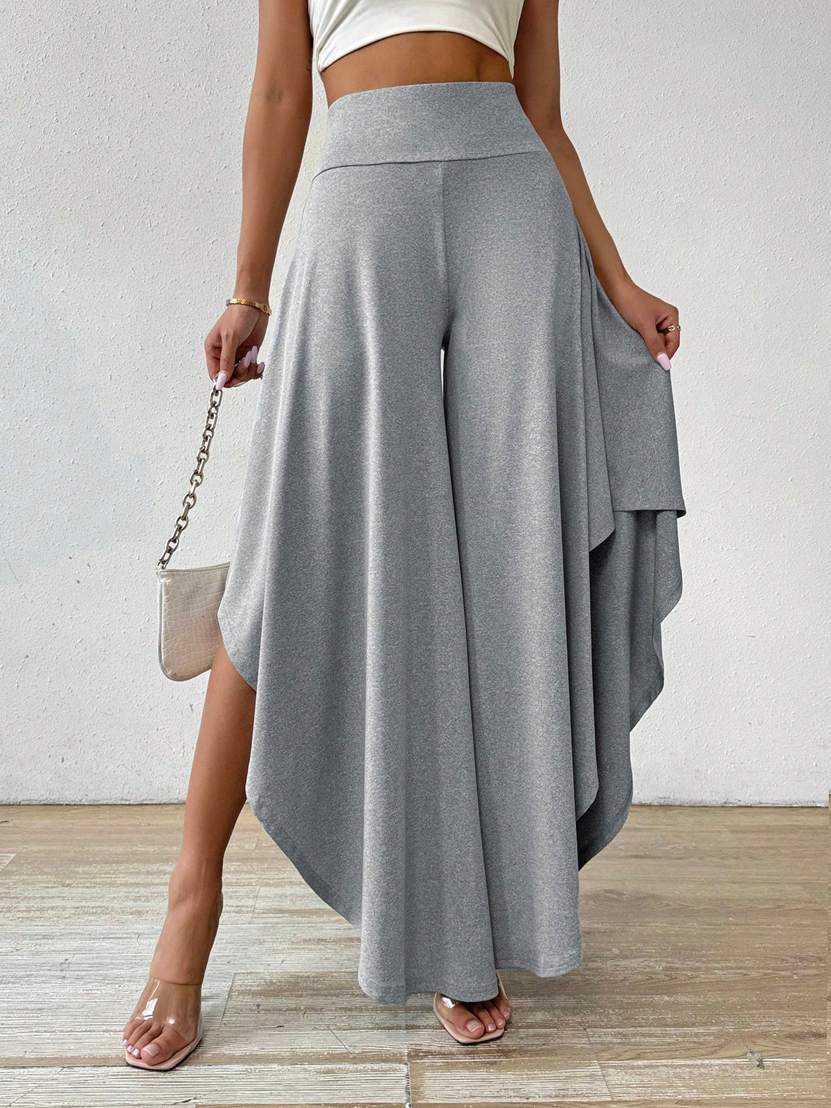 Pantaloni a gamba larga vita alta orlo asimmetrico
