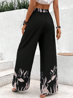 Pantaloni a gamba larga a vita alta con stampa floreale e dettaglio di fiocco sul davanti per donne, neri