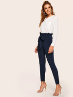 Pantaloni skinny con nodo e vita a volant sovrapposti