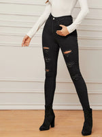 Jeans aderenti strappati senza cintura